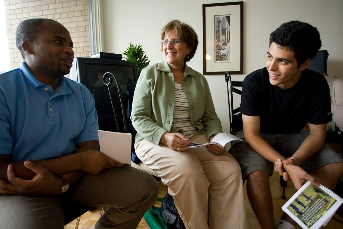 Friends seated together in conversation during a study and reflection gathering